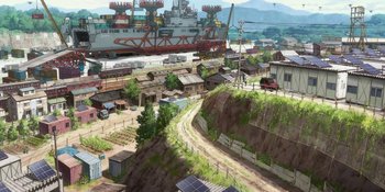 Movie still from “Evangelion: 3.0+1.01 Thrice Upon a Time” (2021), directed by Joe Fria – An artist's rendering of an industrial area with a ship in the background; Extreme Wide shot, High angle