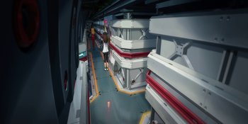 Movie still from “Evangelion: 3.0+1.01 Thrice Upon a Time” (2021), directed by Joe Fria – A woman walking down a hallway in a building; Extreme Wide shot, High angle