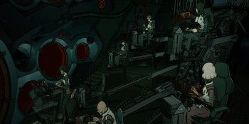 Movie still from “Evangelion: 3.0+1.01 Thrice Upon a Time” (2021), directed by Joe Fria – An illustration of a room with a lot of computer equipment; Extreme Wide shot, High angle