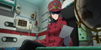 Movie still from “Evangelion: 3.0+1.01 Thrice Upon a Time” (2021), directed by Joe Fria – A woman in a red uniform holding a piece of paper; Medium shot, Low angle