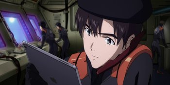 Movie still from “Evangelion: 3.0+1.01 Thrice Upon a Time” (2021), directed by Joe Fria – An anime character looking at the camera with an ipad in front of him; Close Up shot, Over the shoulder angle