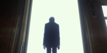 Movie still from “Evangelion: 3.0+1.01 Thrice Upon a Time” (2021), directed by Joe Fria – A man standing in front of a white wall; Wide shot, Low angle