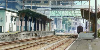 Movie still from “Evangelion: 3.0+1.01 Thrice Upon a Time” (2021), directed by Joe Fria – An empty train station with no one on the tracks; Extreme Wide shot, High angle