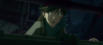 Movie still from “Evangelion: 3.0 You Can (Not) Redo” (2012), directed by Kiyotaka Suzuki – A woman with long brown hair and a green head scarf; Close Up shot, Over the shoulder angle