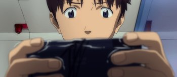 Movie still from “Evangelion: 3.0 You Can (Not) Redo” (2012), directed by Kiyotaka Suzuki – A boy is looking at a cell phone screen; Close Up shot, High angle