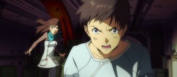 Movie still from “Evangelion: 3.0 You Can (Not) Redo” (2012), directed by Kiyotaka Suzuki – A young man is looking at the camera while a younger man is looking at the camera; Close Up shot, Low angle