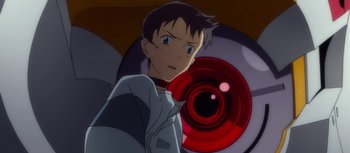 Movie still from “Evangelion: 3.0 You Can (Not) Redo” (2012), directed by Kiyotaka Suzuki – A man standing in front of a red eye; Close Up shot, Low angle