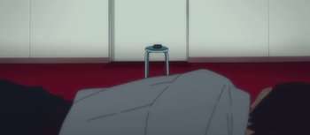 Movie still from “Evangelion: 3.0 You Can (Not) Redo” (2012), directed by Kiyotaka Suzuki – An image of a stool in a room near a window; Wide shot, High angle
