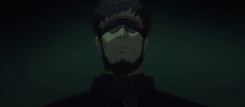 Movie still from “Evangelion: 3.0 You Can (Not) Redo” (2012), directed by Kiyotaka Suzuki – A man with a beard wearing a black jacket; Close Up shot, Low angle