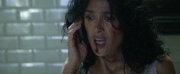 Movie still from “Everly” (2014), directed by Joe Lynch – A person talking on a cell phone; Close Up shot, Overhead angle
