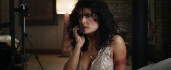 Movie still from “Everly” (2014), directed by Joe Lynch – A woman in a white dress talking on a cell phone; Close Up shot, High angle