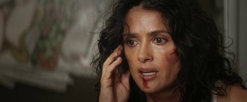 Movie still from “Everly” (2014), directed by Joe Lynch – A person talking on a cell phone; Close Up shot, High angle