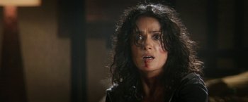 Movie still from “Everly” (2014), directed by Joe Lynch – A person with blood on her face; Close Up shot, Over the shoulder angle