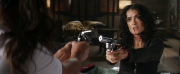 Movie still from “Everly” (2014), directed by Joe Lynch – A woman is holding a gun in her hand; Close Up shot, Over the shoulder angle