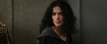 Movie still from “Everly” (2014), directed by Joe Lynch – A person with long curly black hair; Close Up shot, Over the shoulder angle
