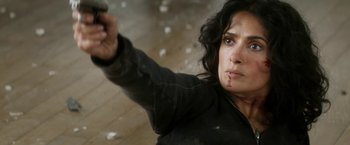 Movie still from “Everly” (2014), directed by Joe Lynch – A woman holding a gun with blood on her face; Close Up shot, Overhead angle
