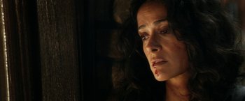 Movie still from “Everly” (2014), directed by Joe Lynch – A person with a knife in her mouth; Close Up shot, High angle