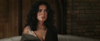 Movie still from “Everly” (2014), directed by Joe Lynch – A woman with blood on her face looking at the camera; Close Up shot, Over the shoulder angle