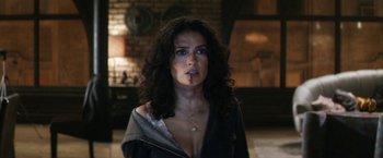 Movie still from “Everly” (2014), directed by Joe Lynch – A beautiful woman with long curly black hair; Close Up shot, Over the shoulder angle