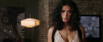 Movie still from “Everly” (2014), directed by Joe Lynch – A woman with long black curly hair wearing a white dress; Close Up shot, Low angle
