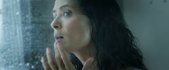 Movie still from “Everly” (2014), directed by Joe Lynch – A woman looking at her reflection in a mirror; Extreme Close Up shot, Low angle