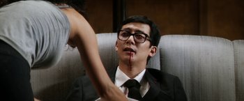Movie still from “Everly” (2014), directed by Joe Lynch – A man in a black suit and a woman in a black suit; Close Up shot, Low angle