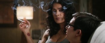 Movie still from “Everly” (2014), directed by Joe Lynch – A woman smoking a cigarette in front of another woman; Close Up shot, Over the shoulder angle