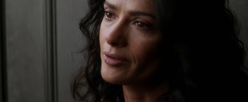 Movie still from “Everly” (2014), directed by Joe Lynch – A woman's face in a dark room; Close Up shot, High angle