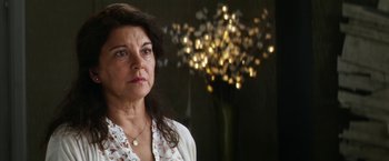 Movie still from “Everly” (2014), directed by Joe Lynch – An older woman standing in front of a tree; Close Up shot, Over the shoulder angle