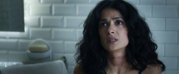 Movie still from “Everly” (2014), directed by Joe Lynch – A person with long black curly hair; Close Up shot, Over the shoulder angle