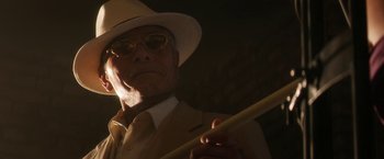 Movie still from “Everly” (2014), directed by Joe Lynch – An older man in a suit and hat holding a cane; Close Up shot, Low angle