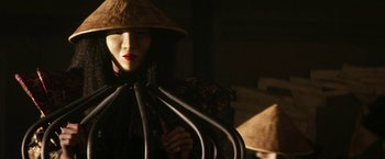 Movie still from “Everly” (2014), directed by Joe Lynch – A woman wearing a hat and holding a bunch of wires in her hands; Close Up shot, Low angle