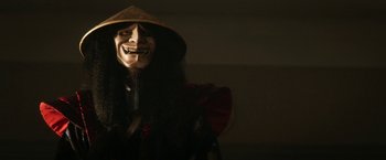 Movie still from “Everly” (2014), directed by Joe Lynch – A person wearing a mask and a hat; Close Up shot, Low angle
