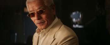 Movie still from “Everly” (2014), directed by Joe Lynch – An older man wearing a white suit and sunglasses; Close Up shot, Low angle