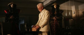 Movie still from “Everly” (2014), directed by Joe Lynch – An old man in a suit and a woman in a white dress; Medium shot, Low angle