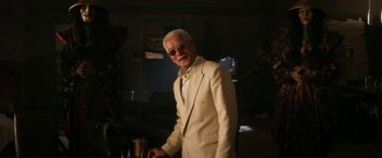 Movie still from “Everly” (2014), directed by Joe Lynch – An older man wearing a white suit and sunglasses; Medium shot, Low angle