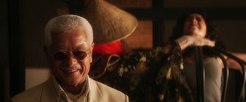 Movie still from “Everly” (2014), directed by Joe Lynch – An older man wearing a suit and sunglasses; Close Up shot, Low angle