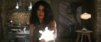 Movie still from “Everly” (2014), directed by Joe Lynch – A woman is holding something in her hand; Close Up shot, Over the shoulder angle