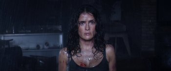 Movie still from “Everly” (2014), directed by Joe Lynch – A person wearing a wetsuit; Close Up shot, Low angle