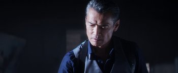 Movie still from “Everly” (2014), directed by Joe Lynch – A person wearing a shirt and tie; Close Up shot, Over the shoulder angle