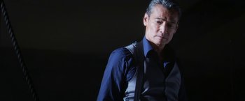 Movie still from “Everly” (2014), directed by Joe Lynch – A person wearing a shirt and tie; Close Up shot, Low angle