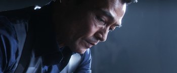 Movie still from “Everly” (2014), directed by Joe Lynch – A person wearing a suit and tie; Close Up shot, Low angle