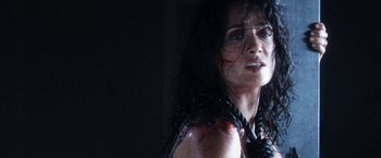 Movie still from “Everly” (2014), directed by Joe Lynch – A person wearing a black shirt; Close Up shot, Over the shoulder angle