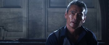 Movie still from “Everly” (2014), directed by Joe Lynch – A person sitting down in a dark room; Close Up shot, Over the shoulder angle