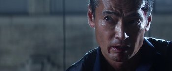 Movie still from “Everly” (2014), directed by Joe Lynch – A person with a face covered in blood; Close Up shot, Over the shoulder angle