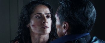 Movie still from “Everly” (2014), directed by Joe Lynch – A man and a woman are looking into each other's eyes; Close Up shot, Over the shoulder angle