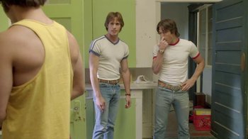 Movie still from “Everybody Wants Some!!” (2016), directed by Richard Linklater – Two young men are standing in front of a bathroom mirror; Medium shot, Over the shoulder angle
