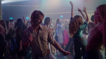 Movie still from “Everybody Wants Some!!” (2016), directed by Richard Linklater – A group of people dancing in a room with lights; Medium shot, Over the shoulder angle