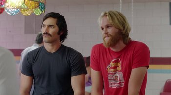 Movie still from “Everybody Wants Some!!” (2016), directed by Richard Linklater – A couple of men standing next to each other; Medium shot, Over the shoulder angle