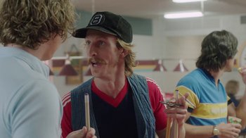 Movie still from “Everybody Wants Some!!” (2016), directed by Richard Linklater – A man in a baseball cap holding a pair of scissors; Close Up shot, Over the shoulder angle